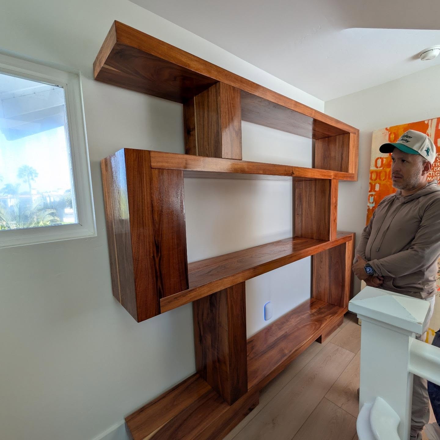 Geometric floating wall shelving unit built from solid hardwood